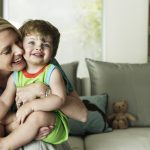 Mother hugging son (Getty Images)