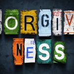 Forgiveness word on vintage broken car license plates, concept sign (Getty Images)